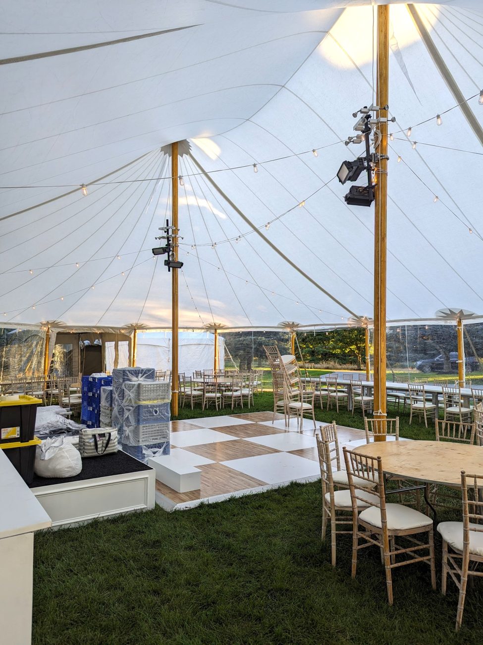 Ceiling lighting glowing inside a sailcloth tent rental at night